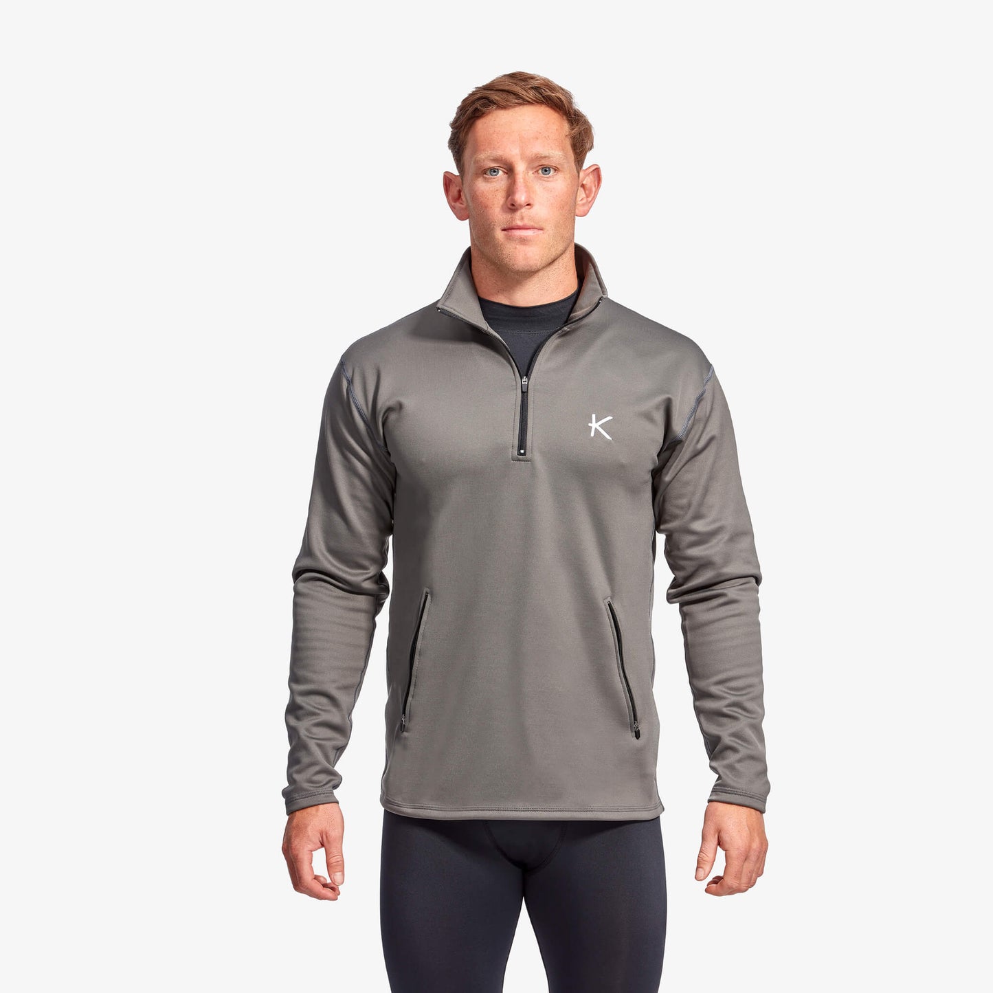 Man wearing Kymira Men’s Infrared Half Zip Fleece — infrared mid-layer with temperature-regulating technology. Grey