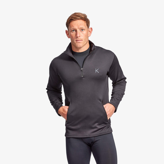 Man wearing Kymira Men’s Infrared Half Zip Fleece — infrared mid-layer with temperature-regulating technology. Black