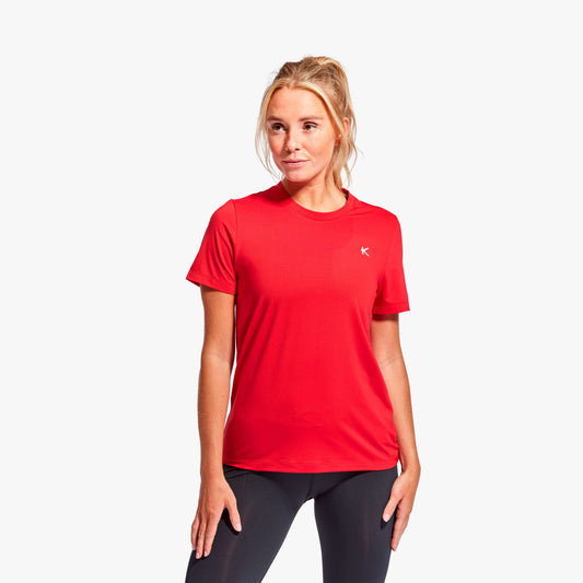 Woman wearing Kymira Women’s Infrared Recovery T-Shirt, lightweight recovery wear with infrared technology. Red