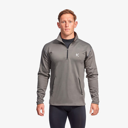 Man wearing Kymira Men’s Infrared Half Zip Fleece — infrared mid-layer with temperature-regulating technology. Grey
