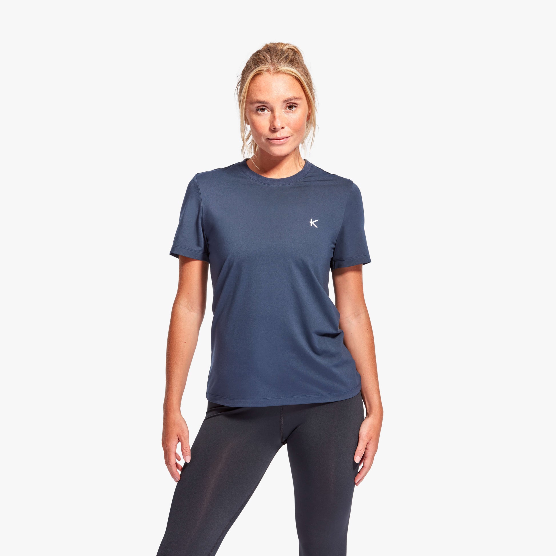 Woman wearing Kymira Women’s Infrared Recovery T-Shirt, lightweight recovery wear with infrared technology. Navy